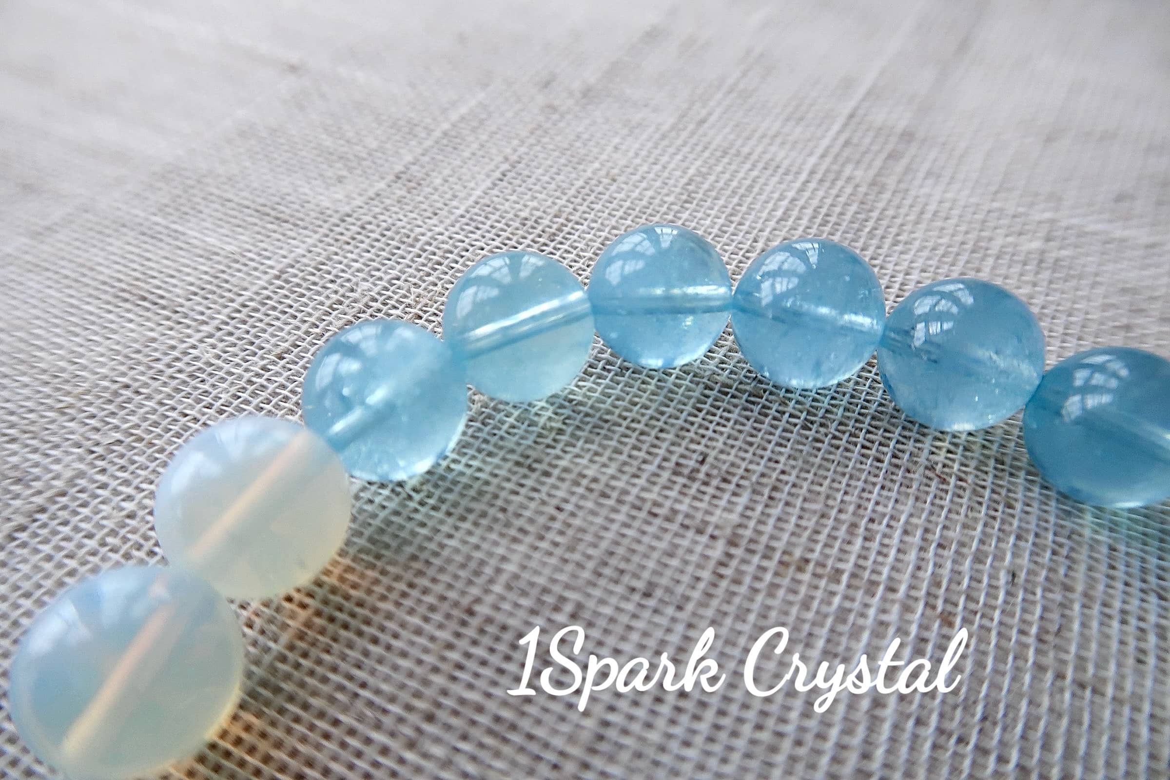 Close-up of Inner Wisdom bracelet featuring aquamarine crystals, showcasing their smooth texture and tranquil blue hues