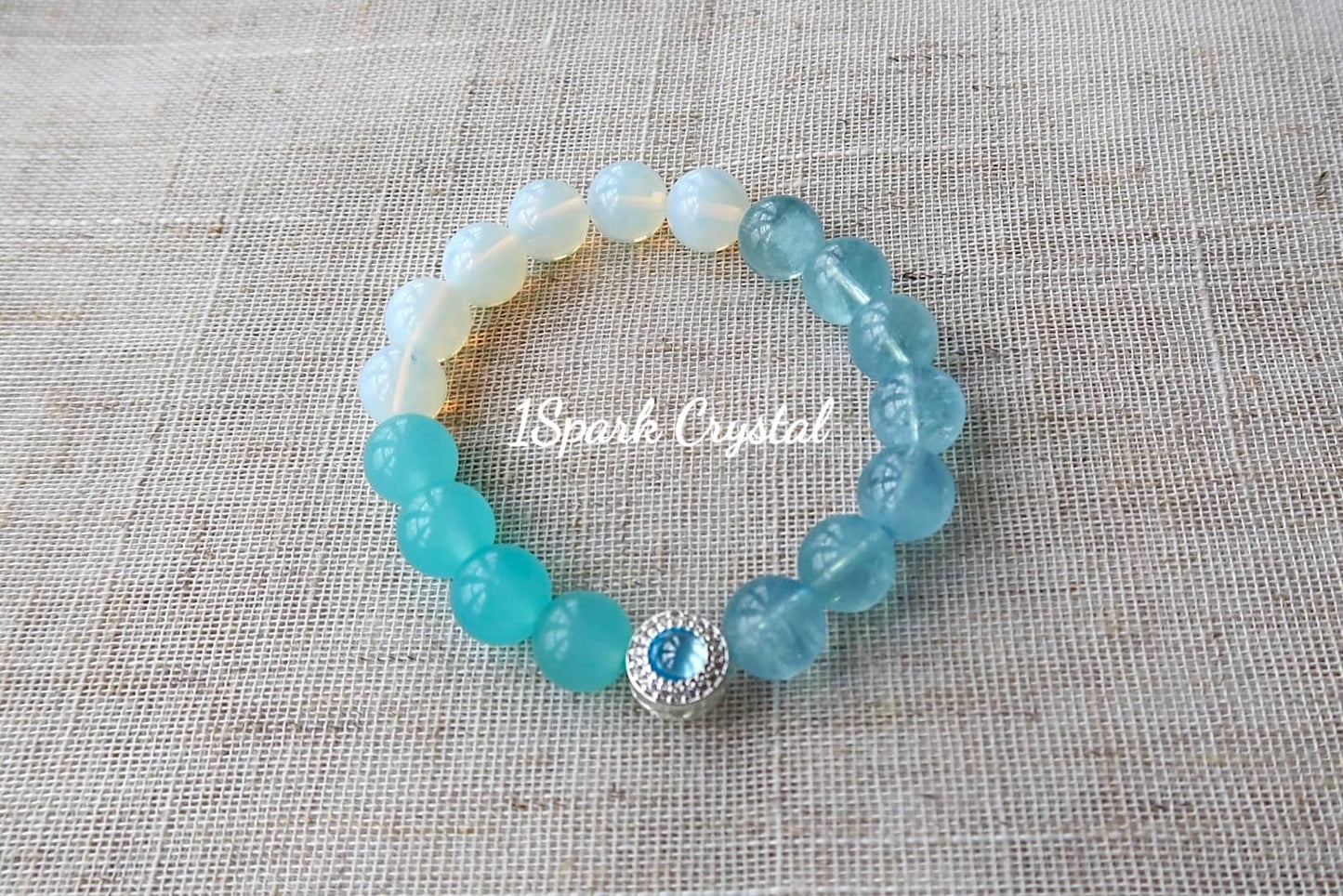 Inner Wisdom handmade crystal bracelet featuring aquamarine, amazonite, and opal, elegantly displayed in a full view showcasing its calming design and soothing color palette