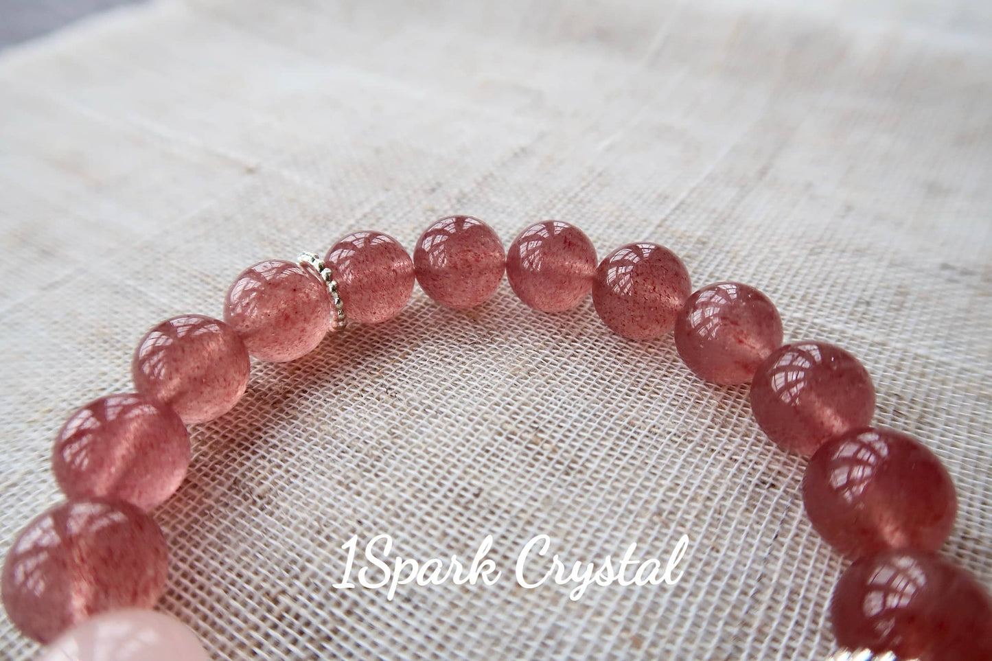 Close-up of Love Manifestation bracelet, highlighting the smooth texture and natural beauty of the strawberry quartz crystal