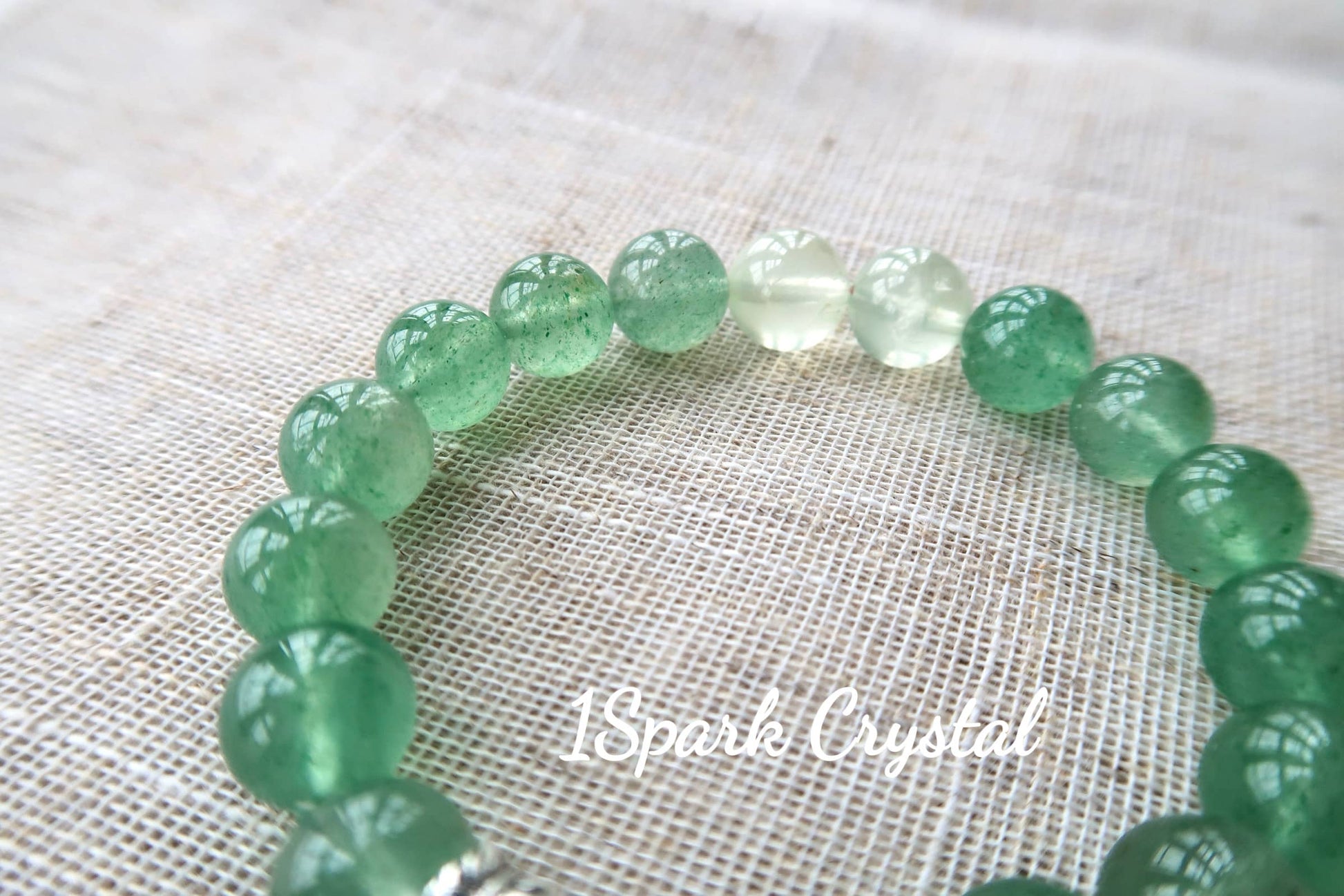 Close-up of Mindful Journey bracelet showcasing the smooth texture and vibrant green hues of green strawberry quartz, promoting emotional balance and mindfulness