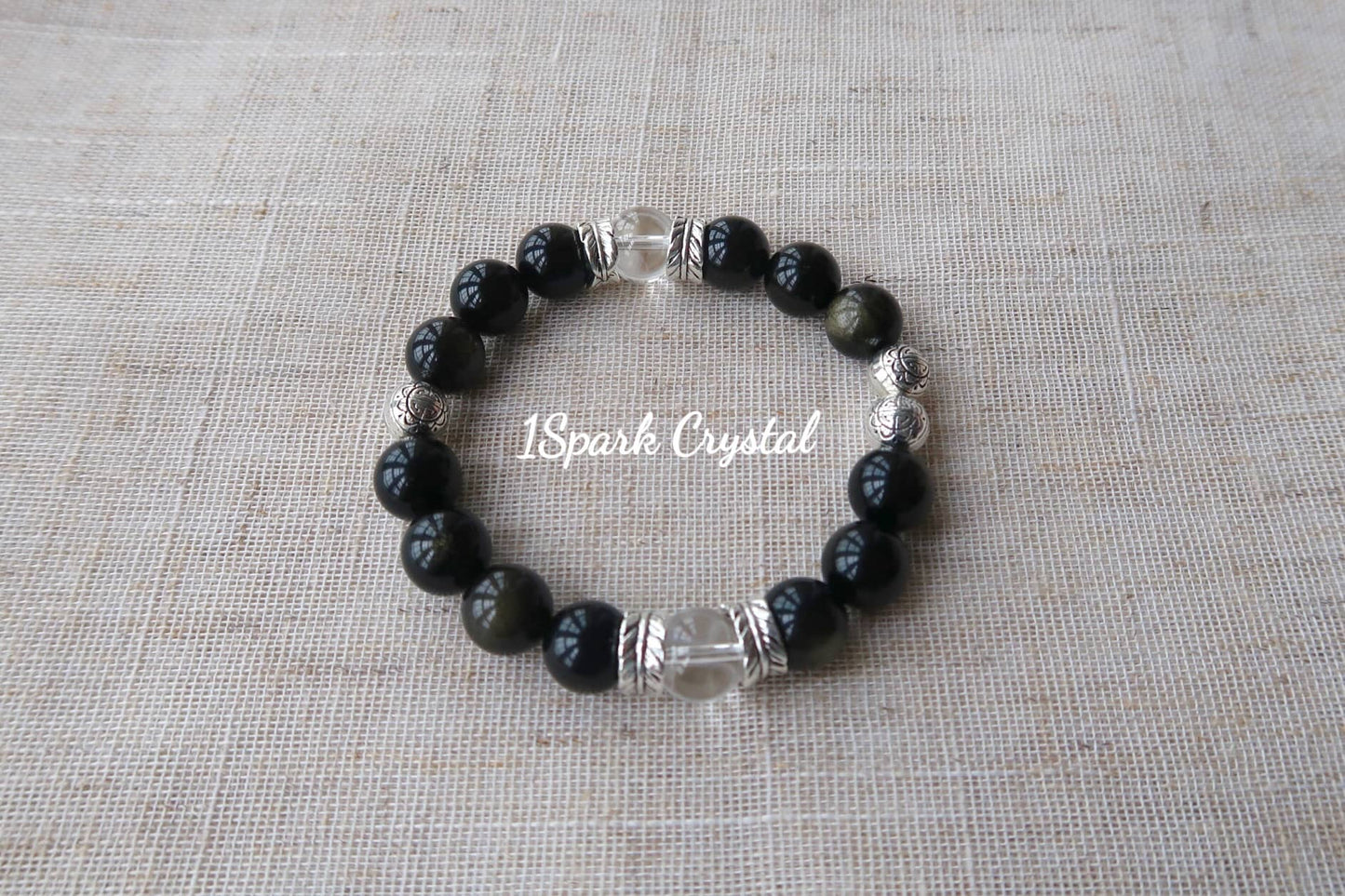 Full view of the Mystic Protection bracelet, highlighting the striking black obsidian and clear quartz crystals paired with silver elements, perfect for spiritual protection