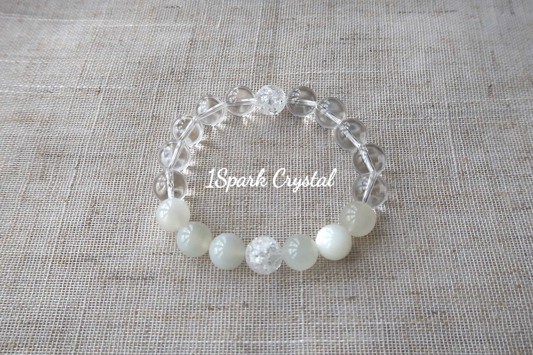 Soul Cleanse handmade crystal bracelet with clear quartz and white moonstone, displayed in a full view highlighting its serene and calming design